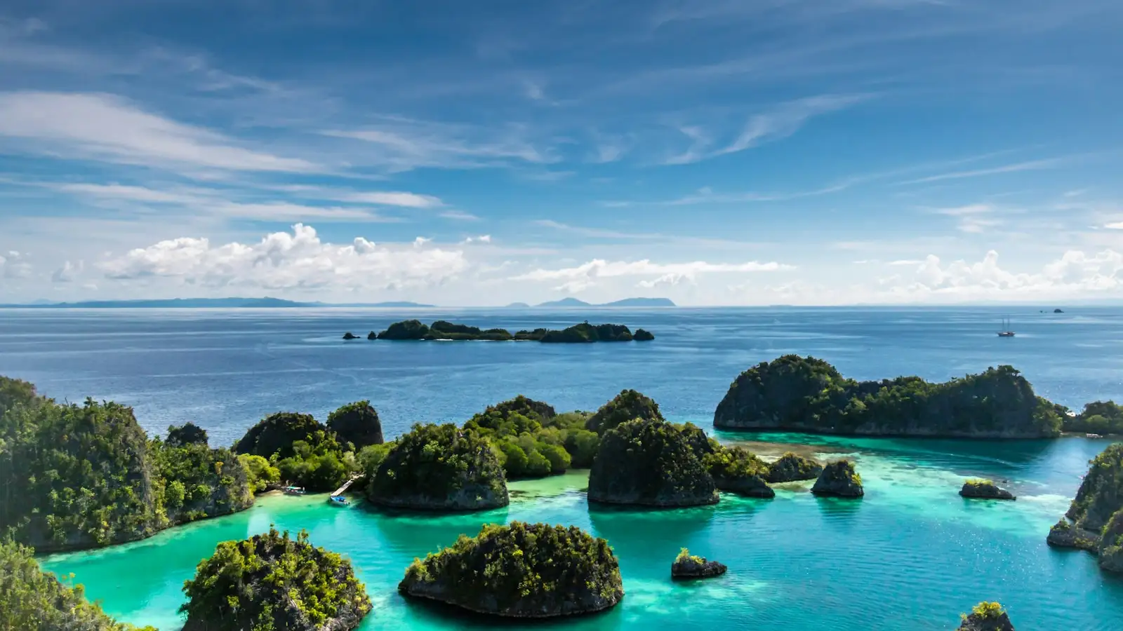 Private yacht charter sailing through Komodo National Park near Labuan Bajo at golden hour
